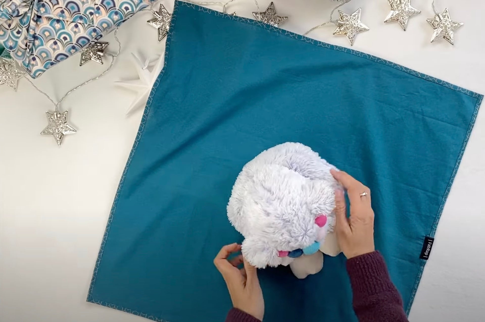 Load video: Furoshiki wrapping a soft plush toy