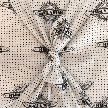 Furoshiki FabRap Reusable fabric gift wrapping. Furoshiki. White with black print starburst design design furoshiki. Exclusive designed furoshiki by FabRap. Zero waste gift wrap by FabRap. FabRap Furoshiki. FabRap fabric gift wrapping.